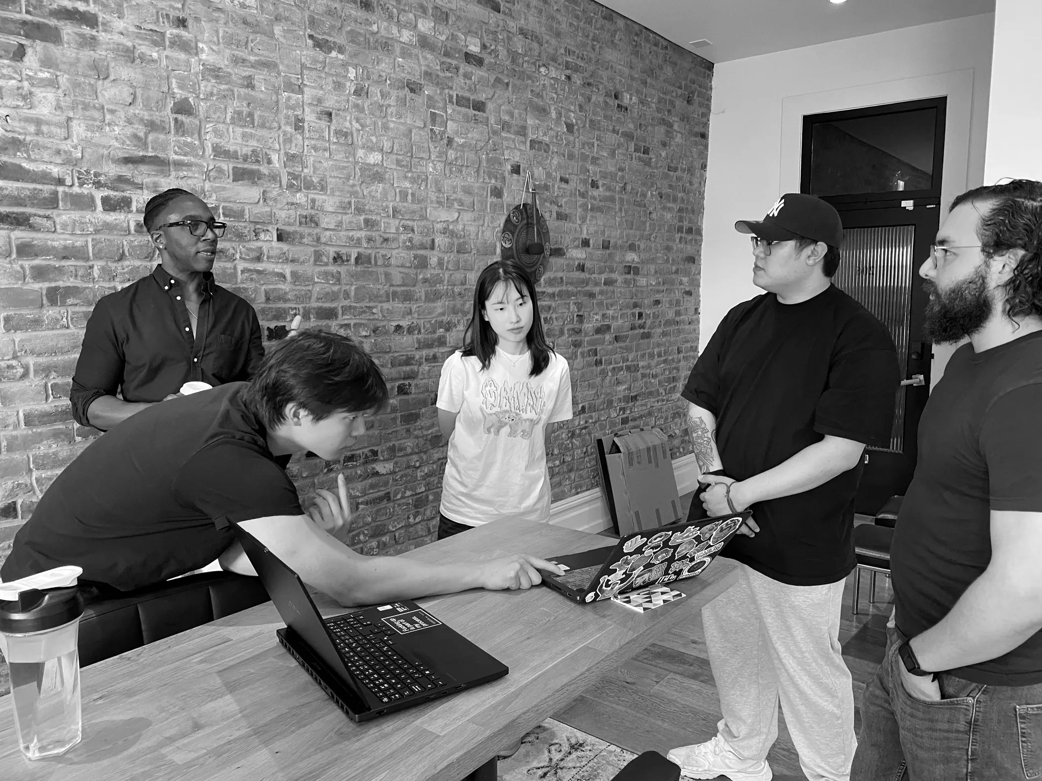 Gathered around a laptop demo at the big table