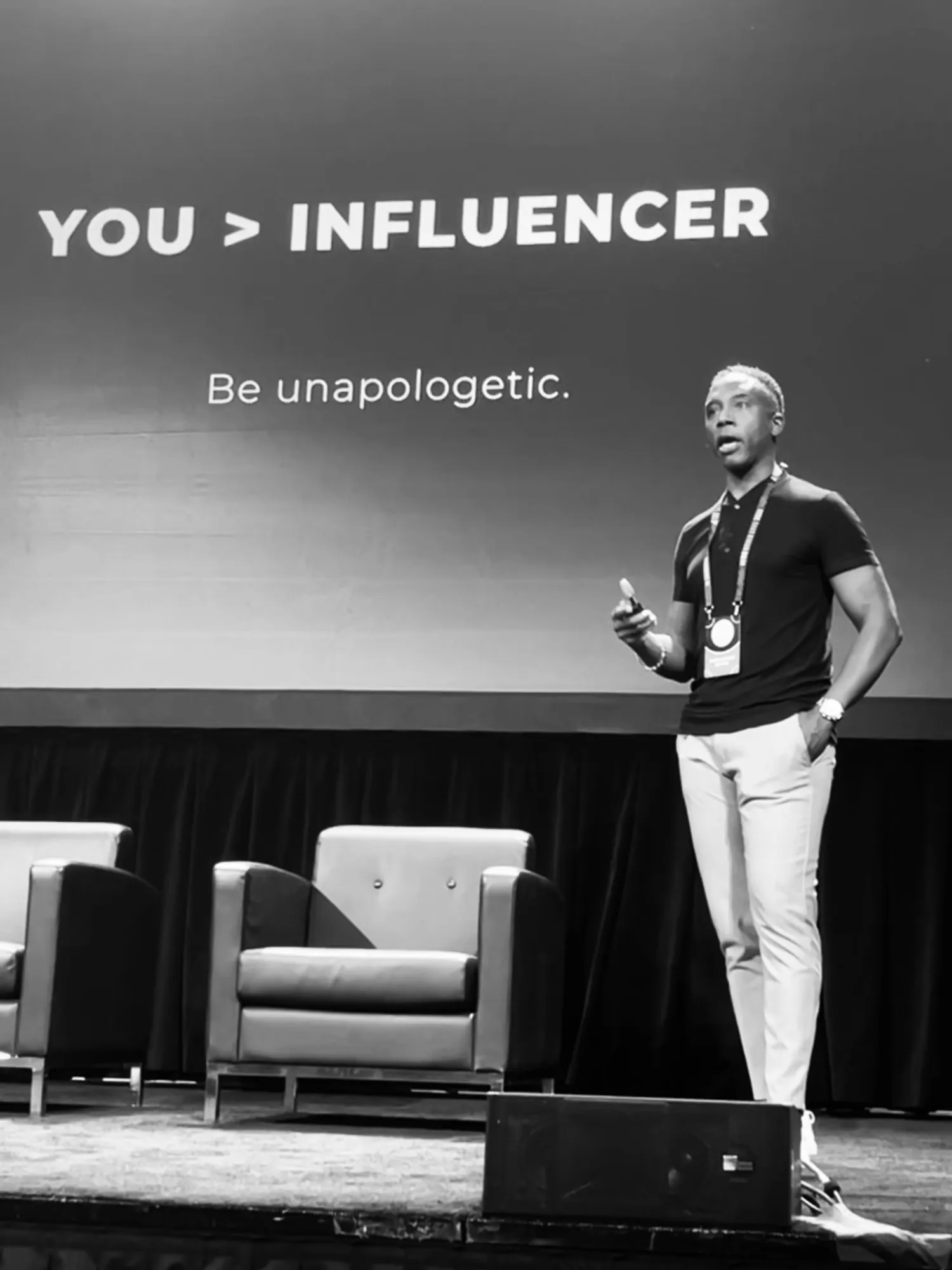 Speaking on stage under a screen that reads You > Influencer
